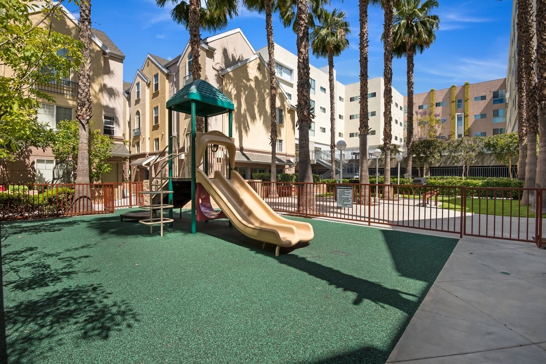 Image of the building play area with green grass carpet