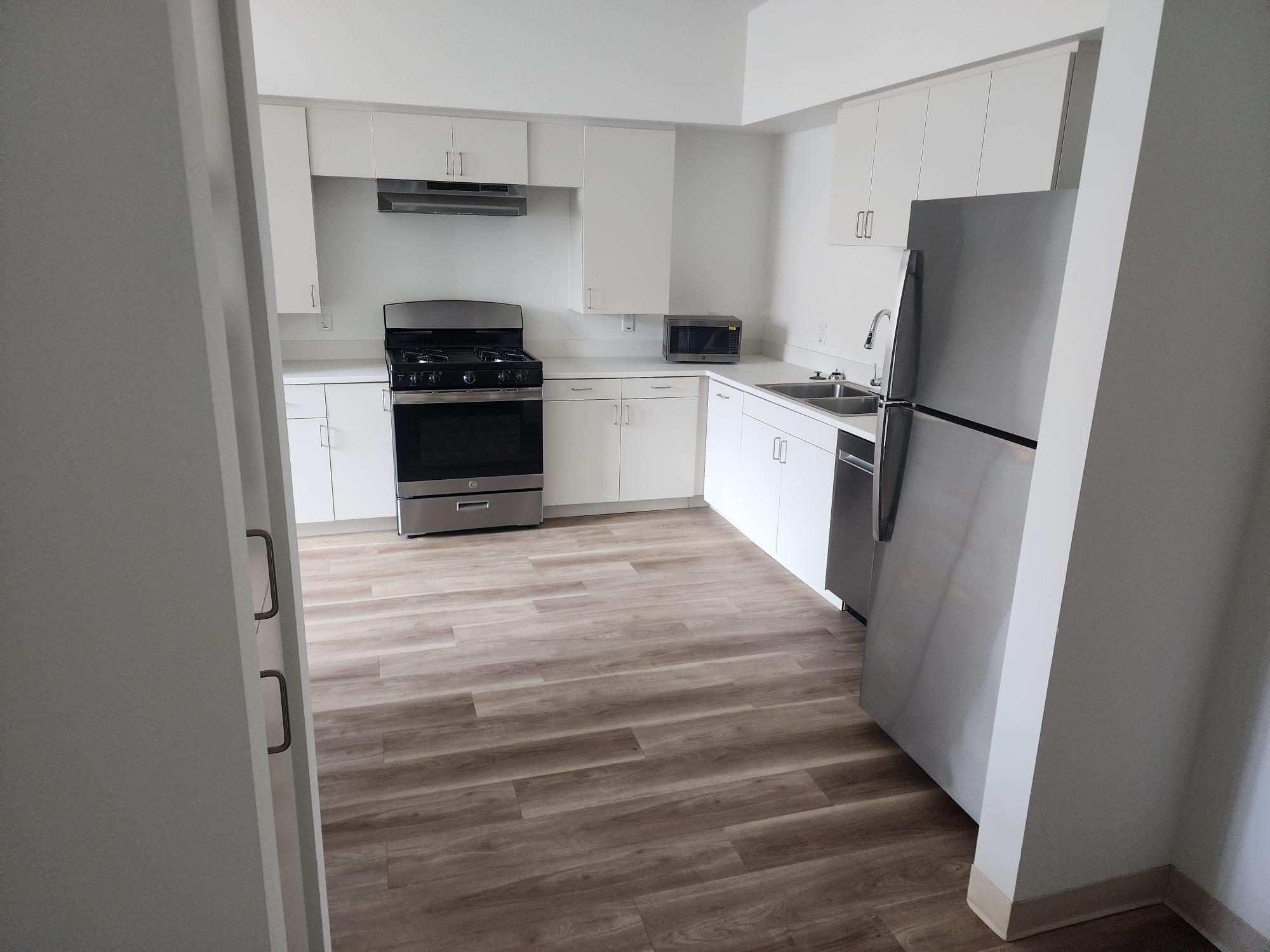 Photo of Bldg exterior and unit kitchen