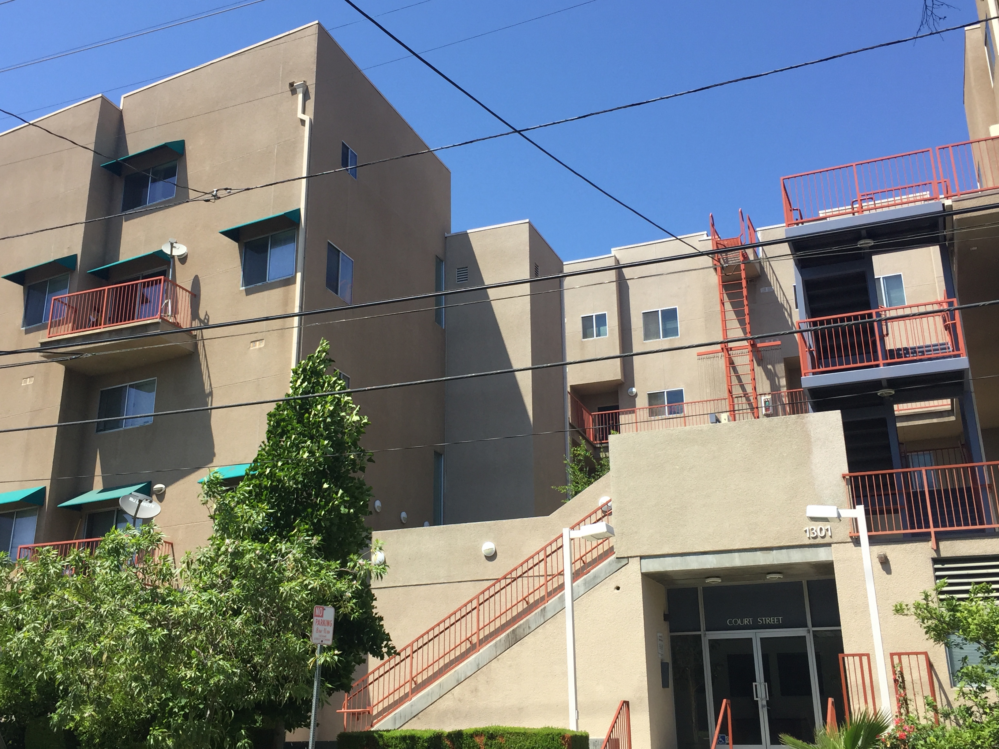 Street view of a three story building in biege color