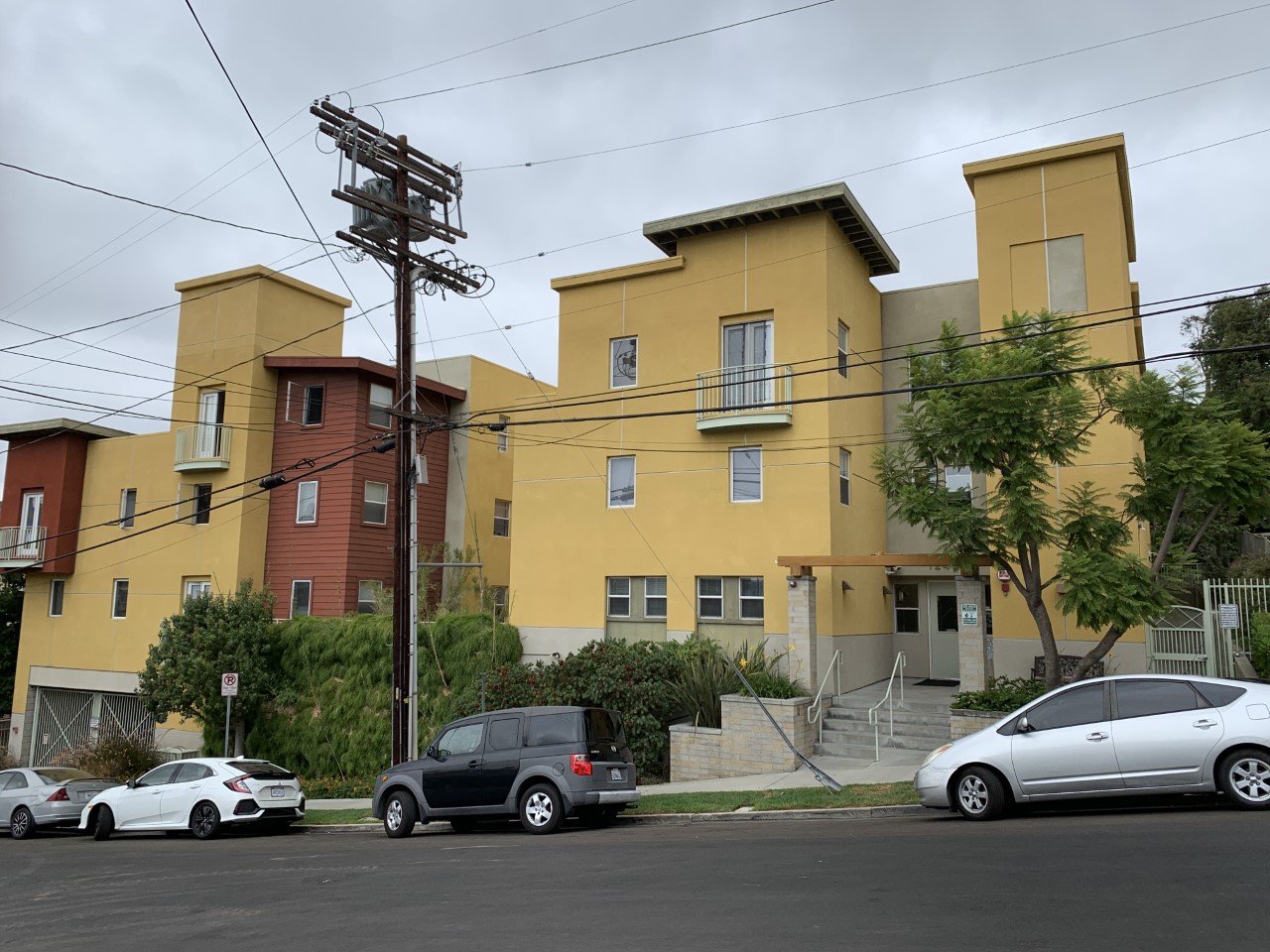 Street view of Innes Heights Apartments. Multi-Level building with cars parked on the street