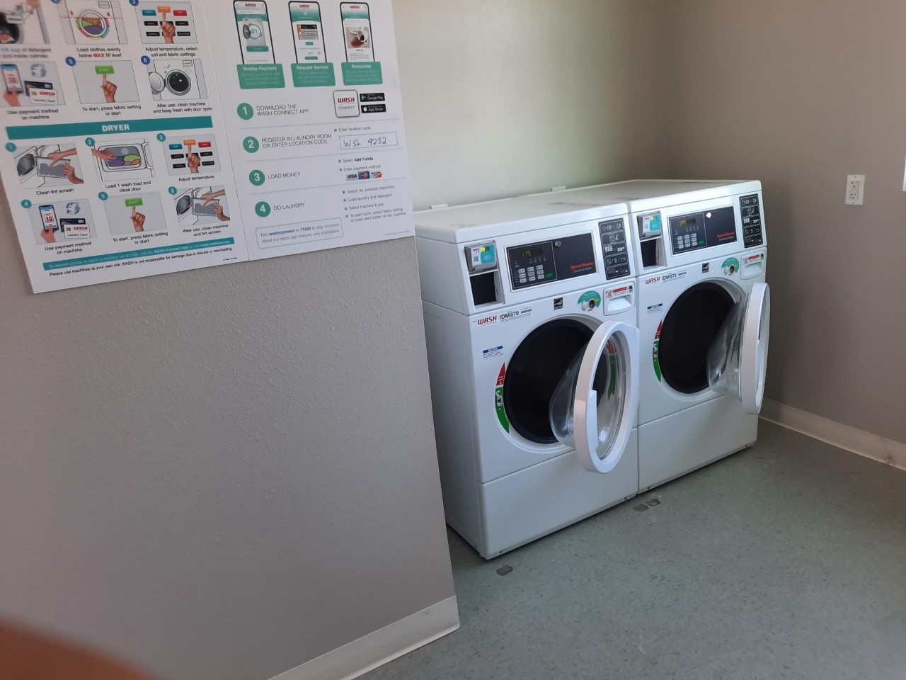 Laundry Room with front loading washer and dryer and tiled flooring. There is a poster on the wall describing how to use the washer and dryer.