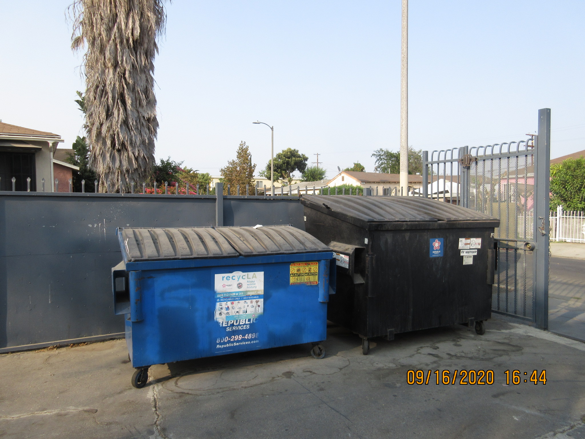lexington a & b apartments dumpster area. Large waste dumpster and large recycling bin