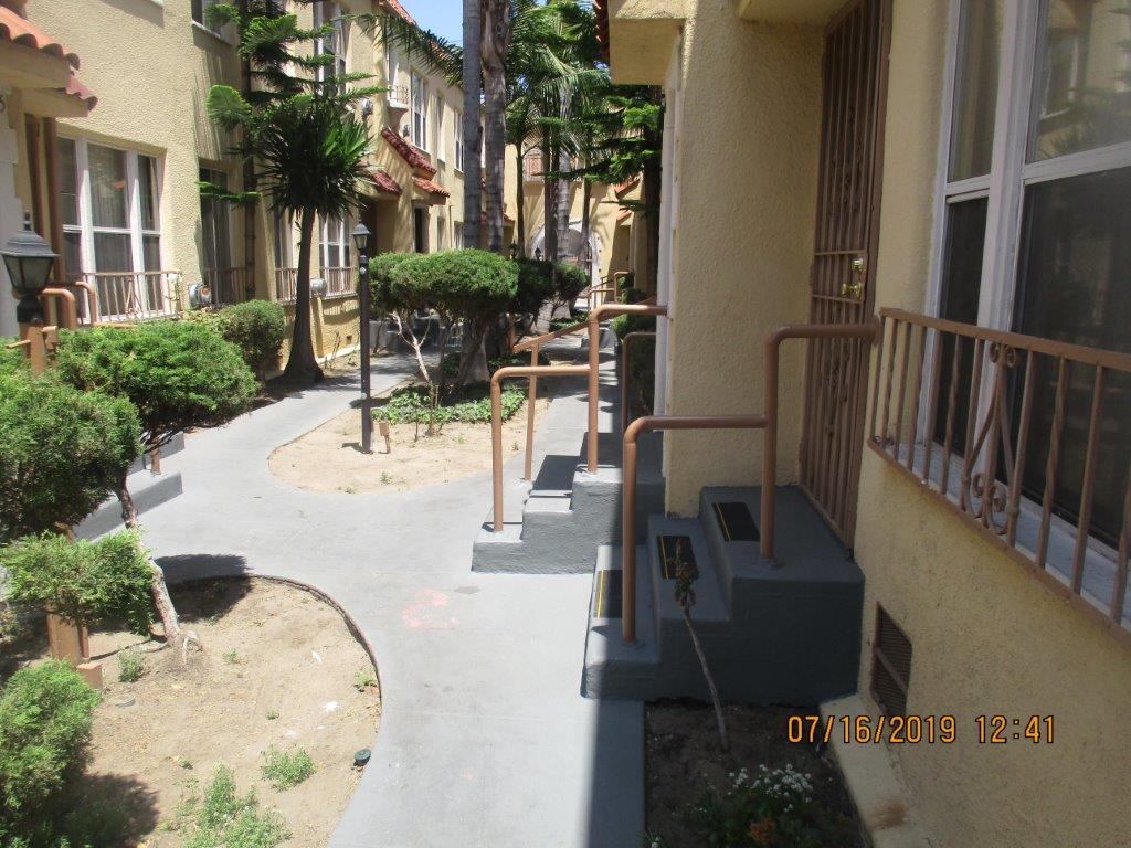 Image of pathway in between units with landscaping around.
