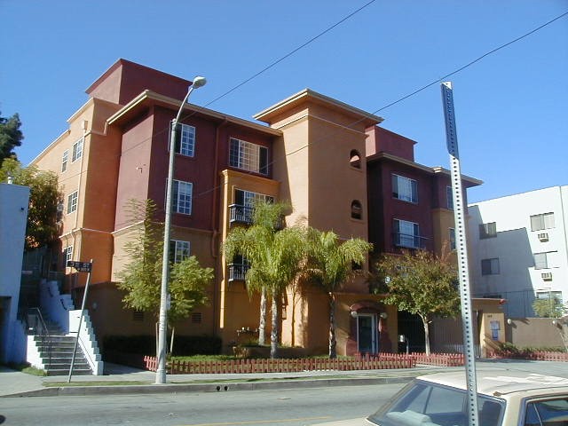 Street view of a three story apartment building in brown color