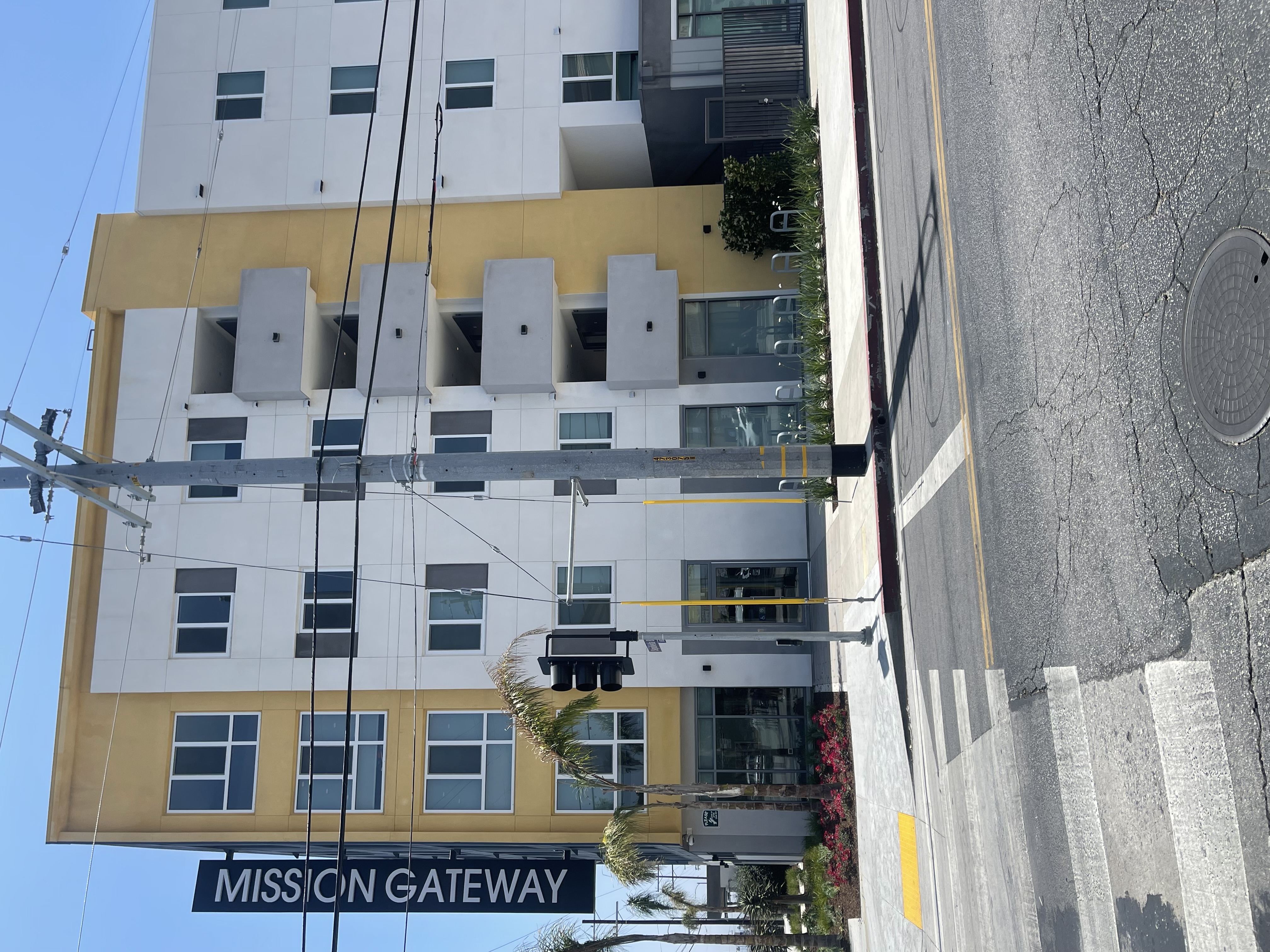 Mission Gateway Front Entrance Sepulveda Blvd and Rayen. There is greenery surrounding the building. .