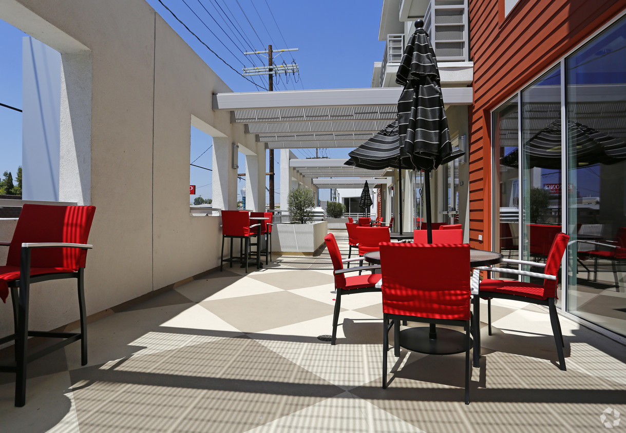Image of the building terrace patio equipped with red chairs
