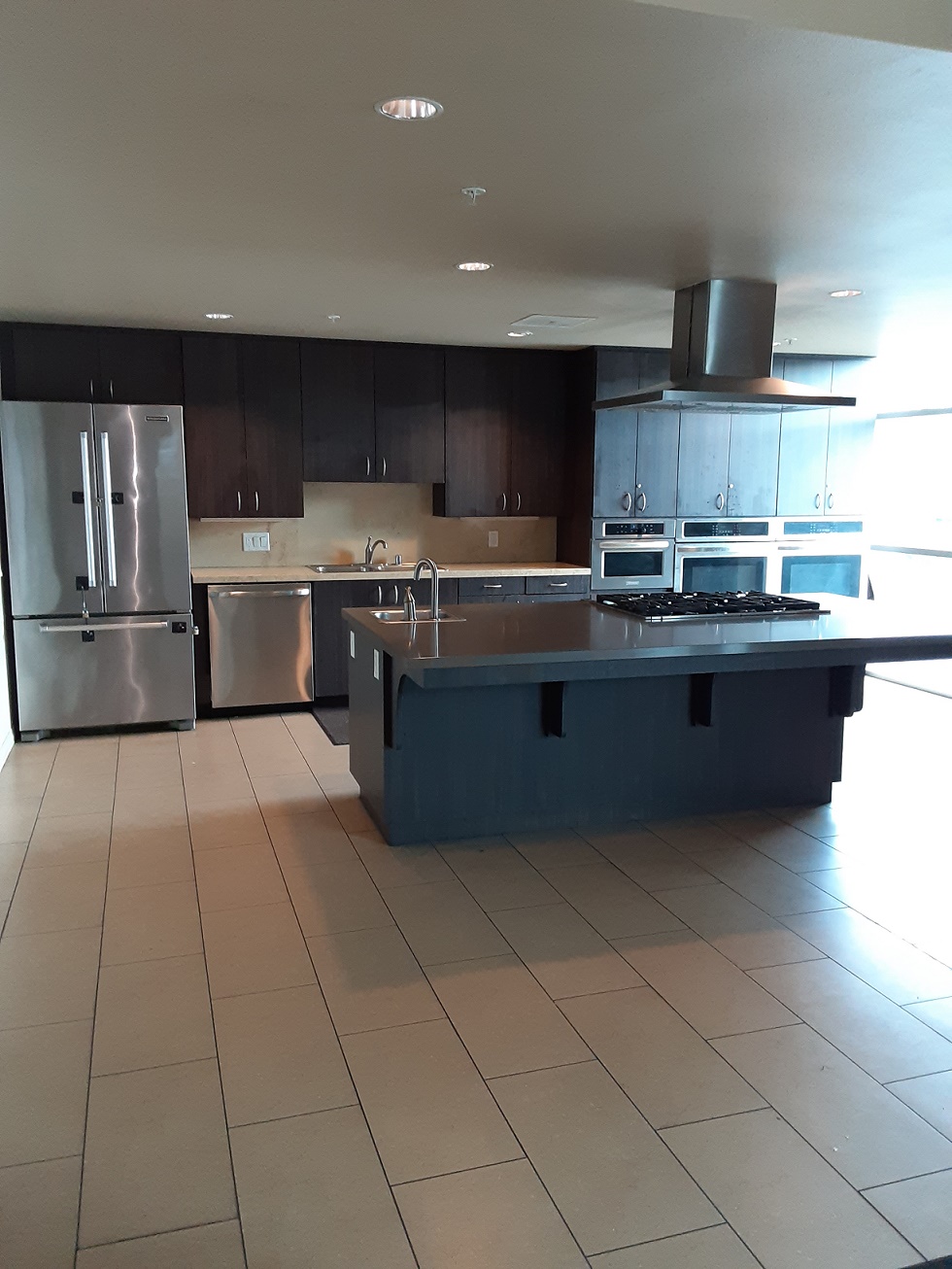 image of gateways kitchen area. large kitchen with upper and lower cabinets. appliances include but not limited to over, dish washer, and fridge.