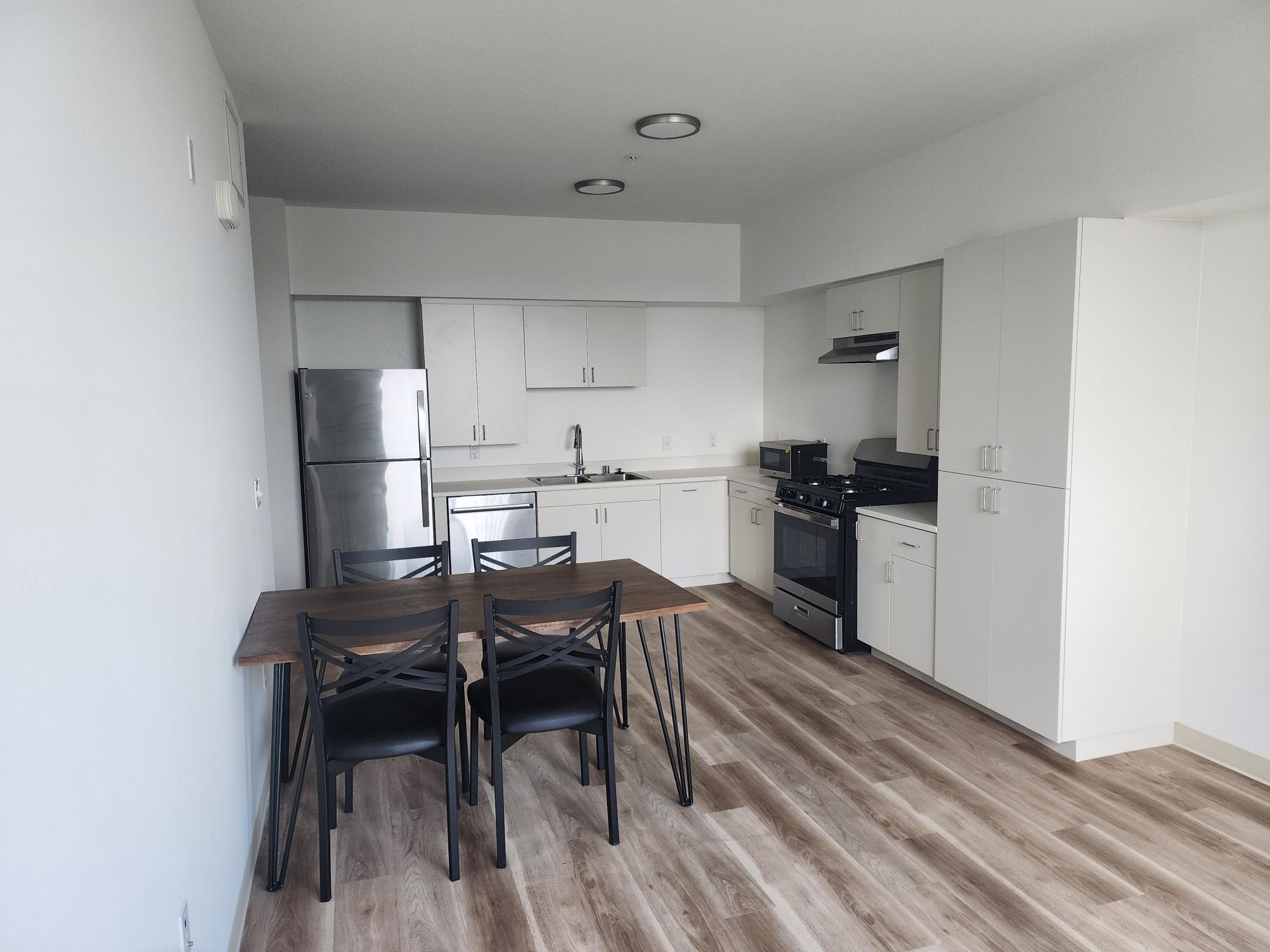 Photo of Bldg exterior and unit kitchen