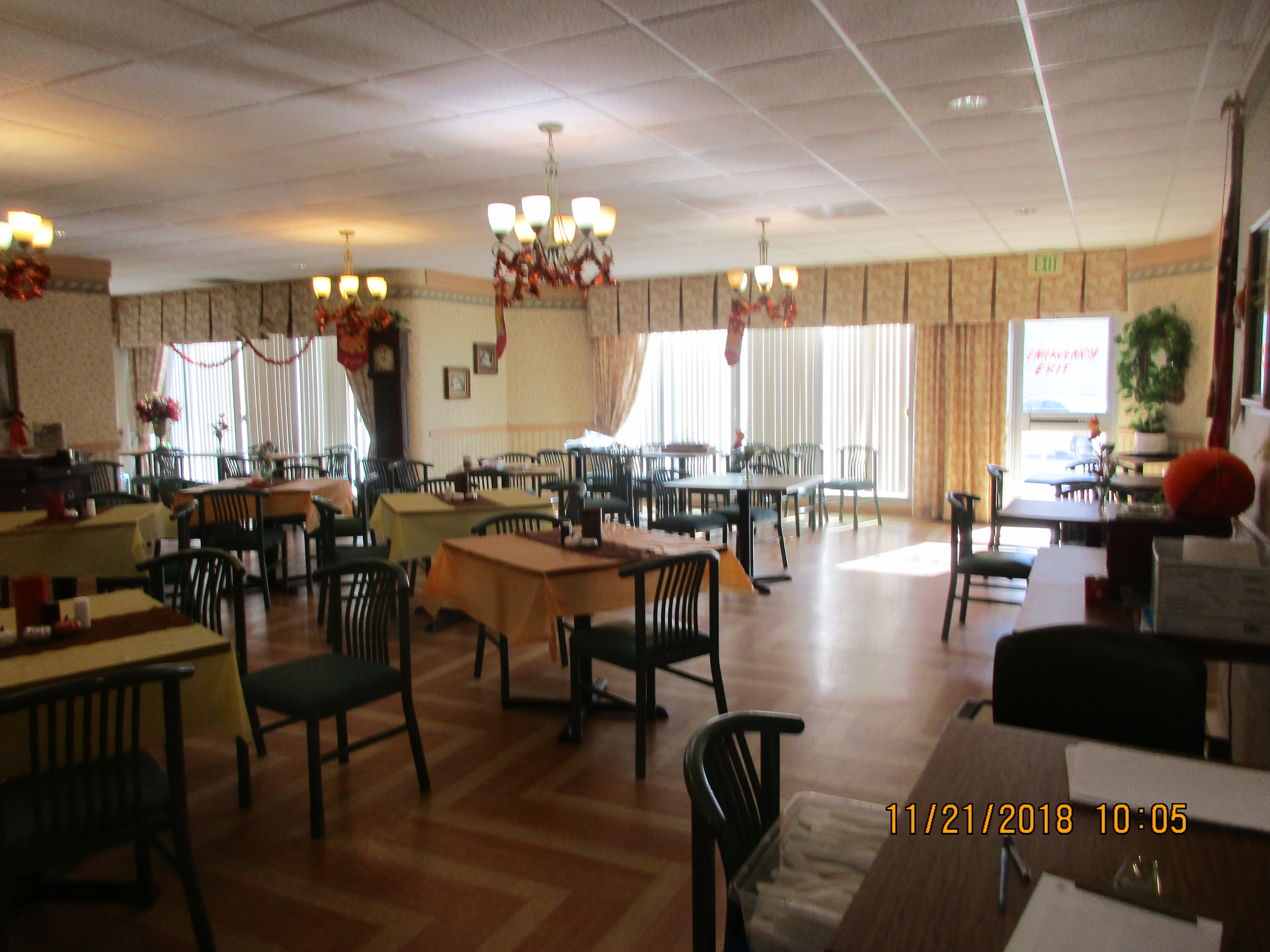 Inside view of the dining room equipped with tables and chairs