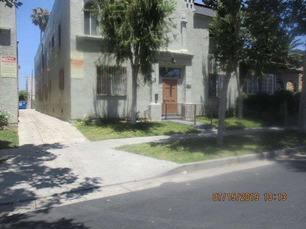 Street view of property showing a driveway to the back of the building