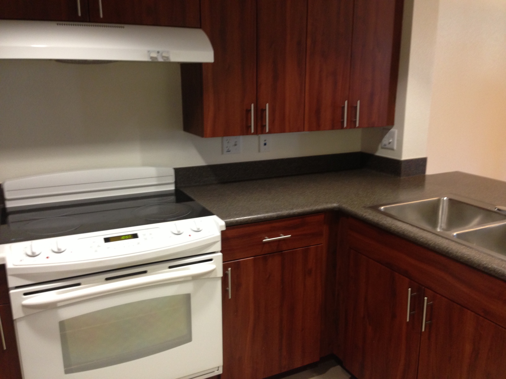 Interior view of a kitchen at Rio Vista Apartments showing a stove, kitchen sink and cabinets