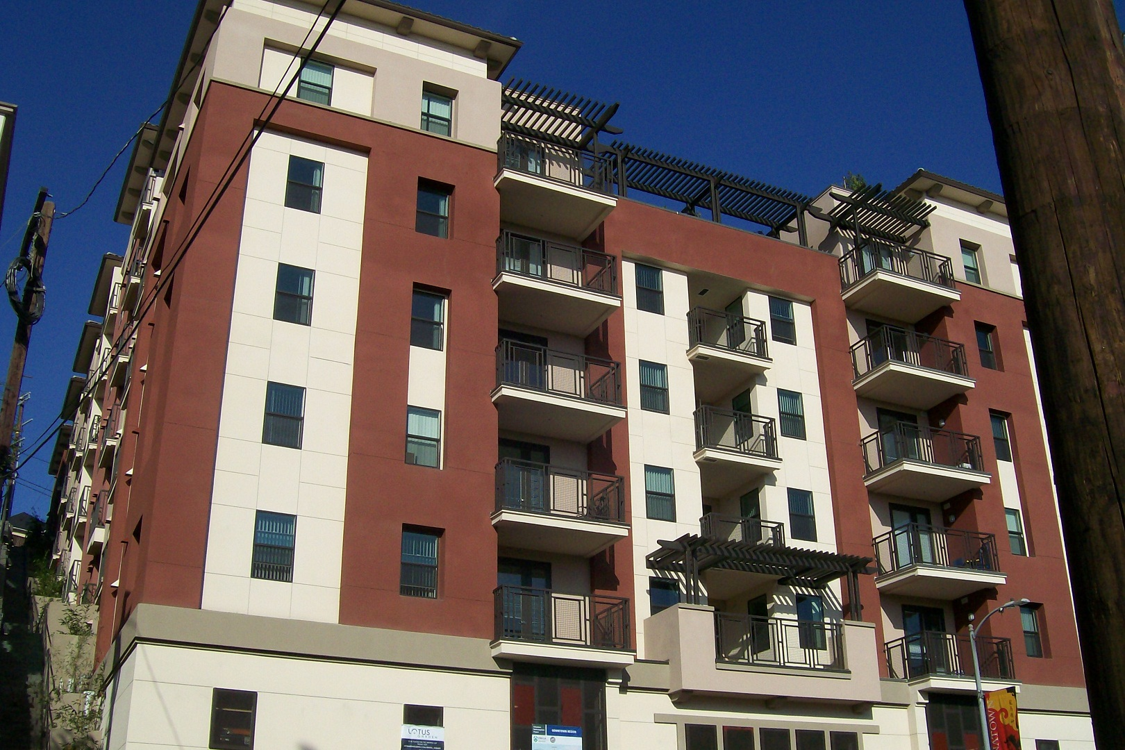 Image of 6 story building with balconies and outside corridors