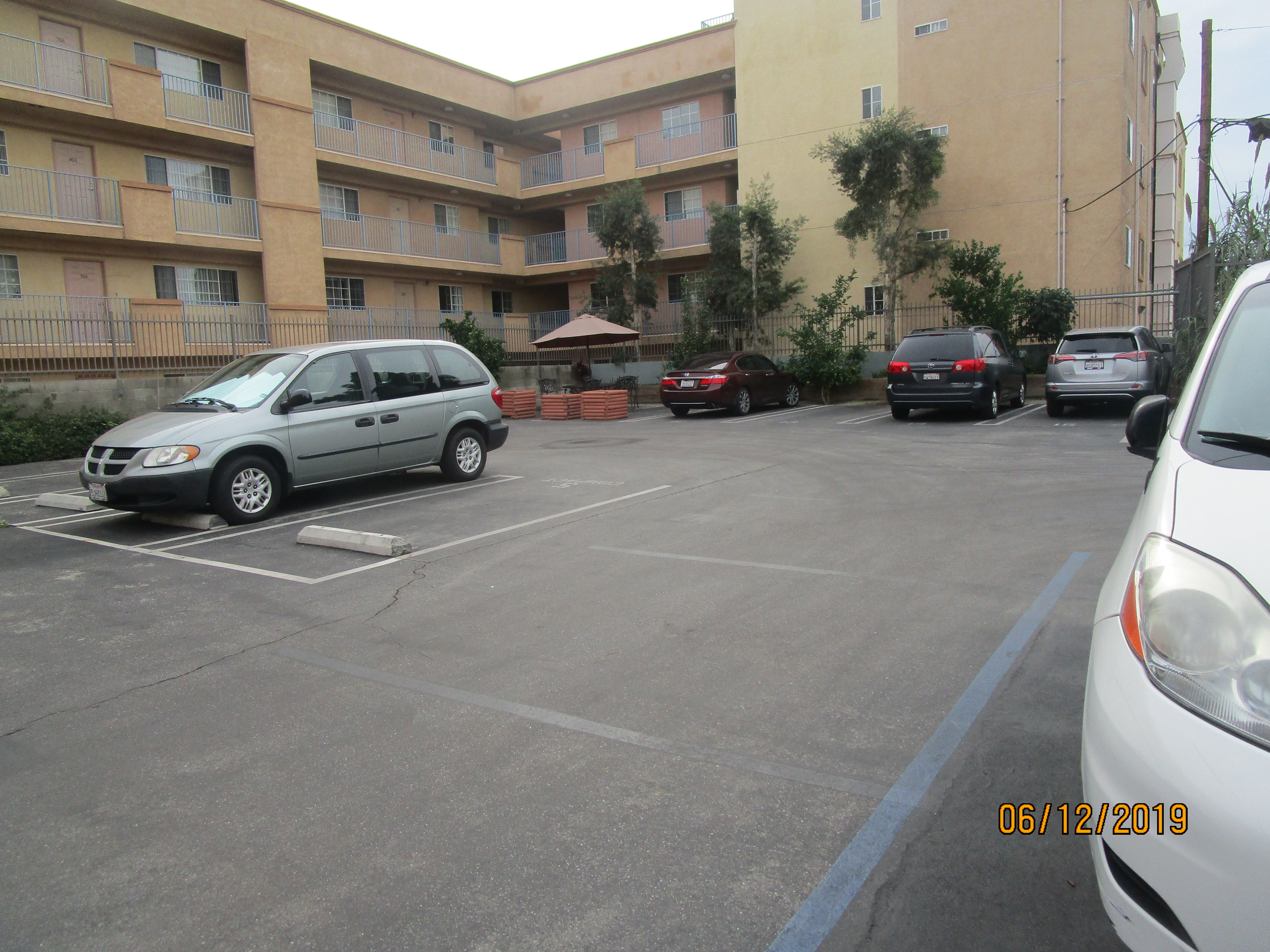 Image of the building parking lot with few cars parked