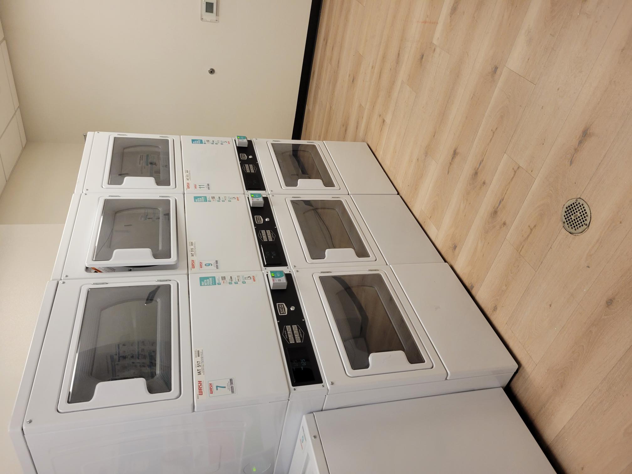 Image of 6 dryers in laundry room.
