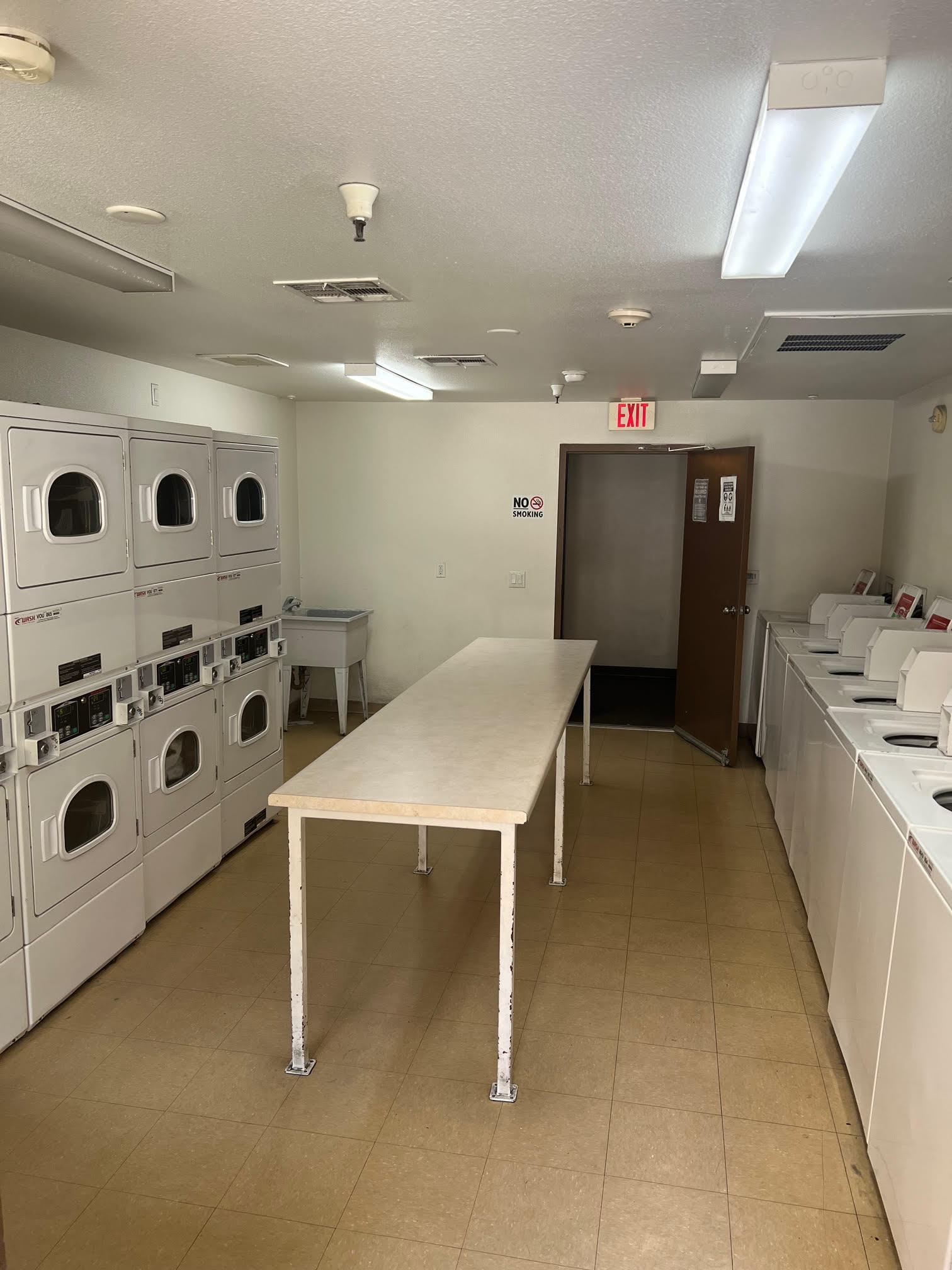 Photo of laundry room showing multiple washers and dryers