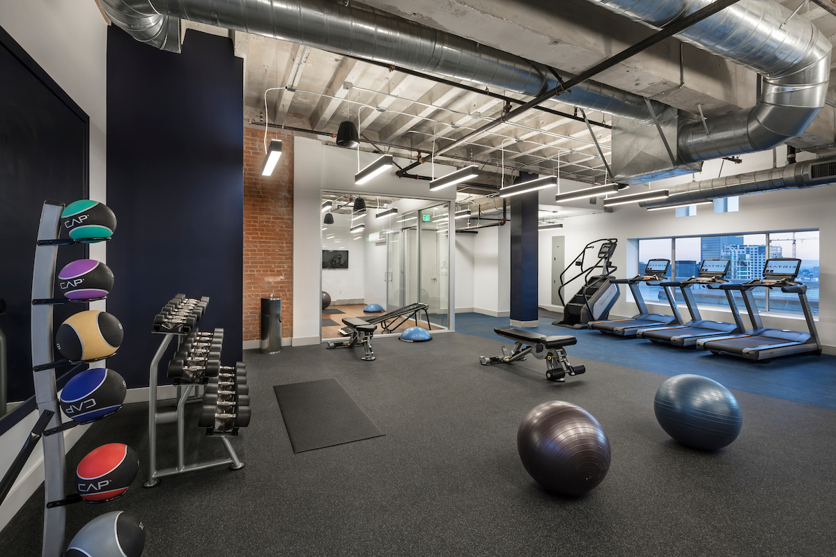 Image of gas company losts community fitness center. large fitness center with several kids of workout machines. There are also exercise balls, medicine balls, and free weights available