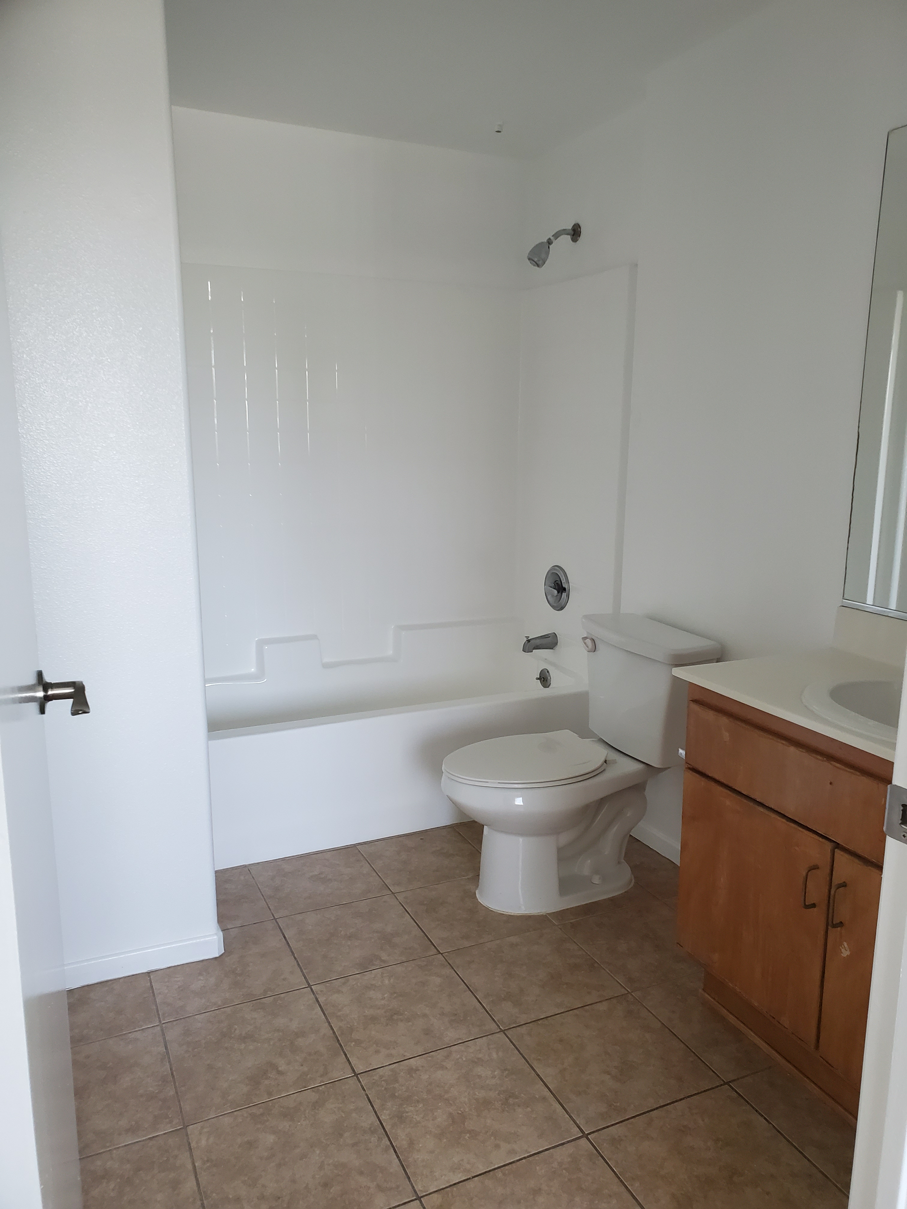 Bathroom with sink, cabinet, and shower bath with fixed head