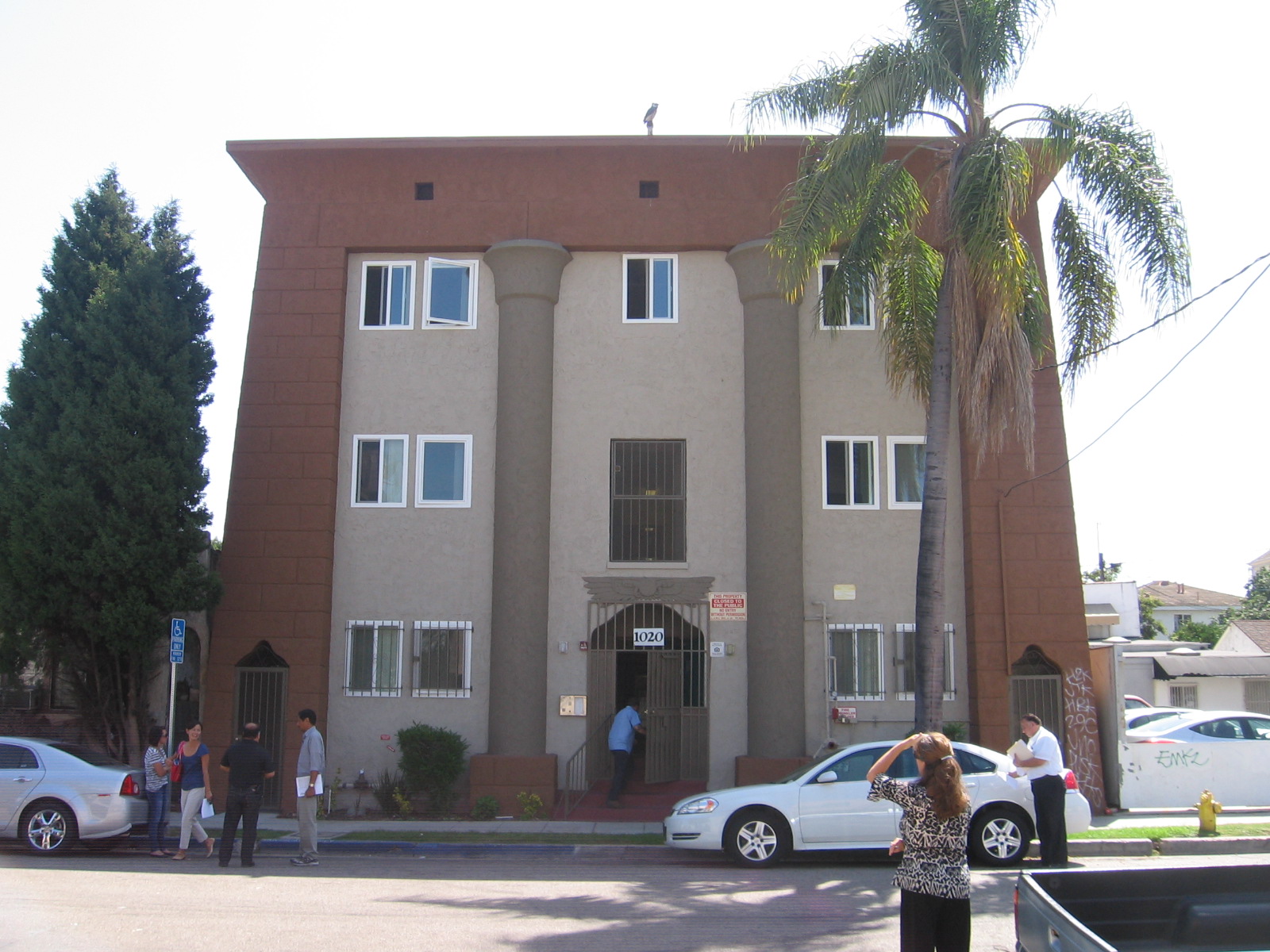 Front view of a two story building in brown and light grey color