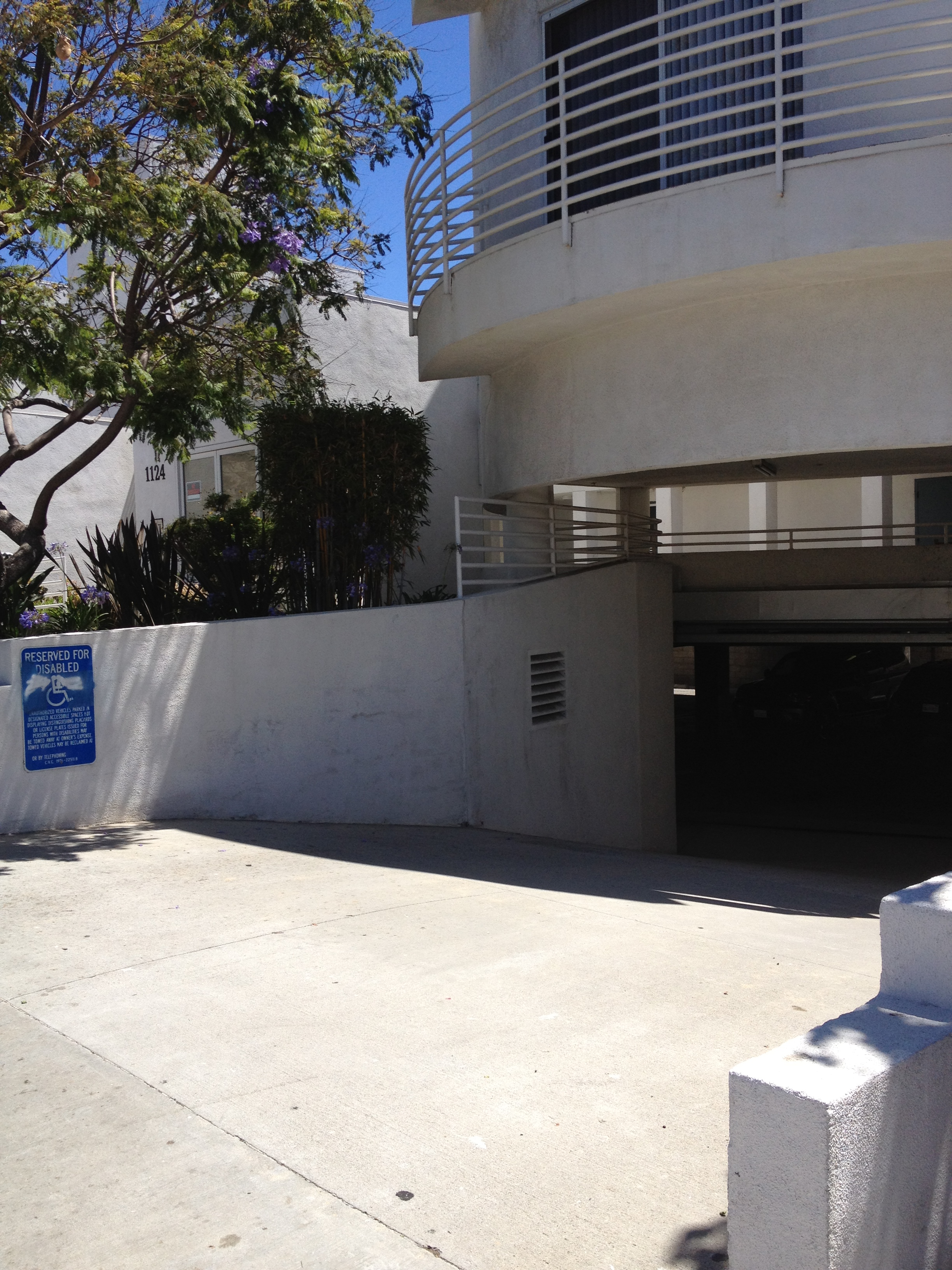 view of driveway leading to under ground parking area