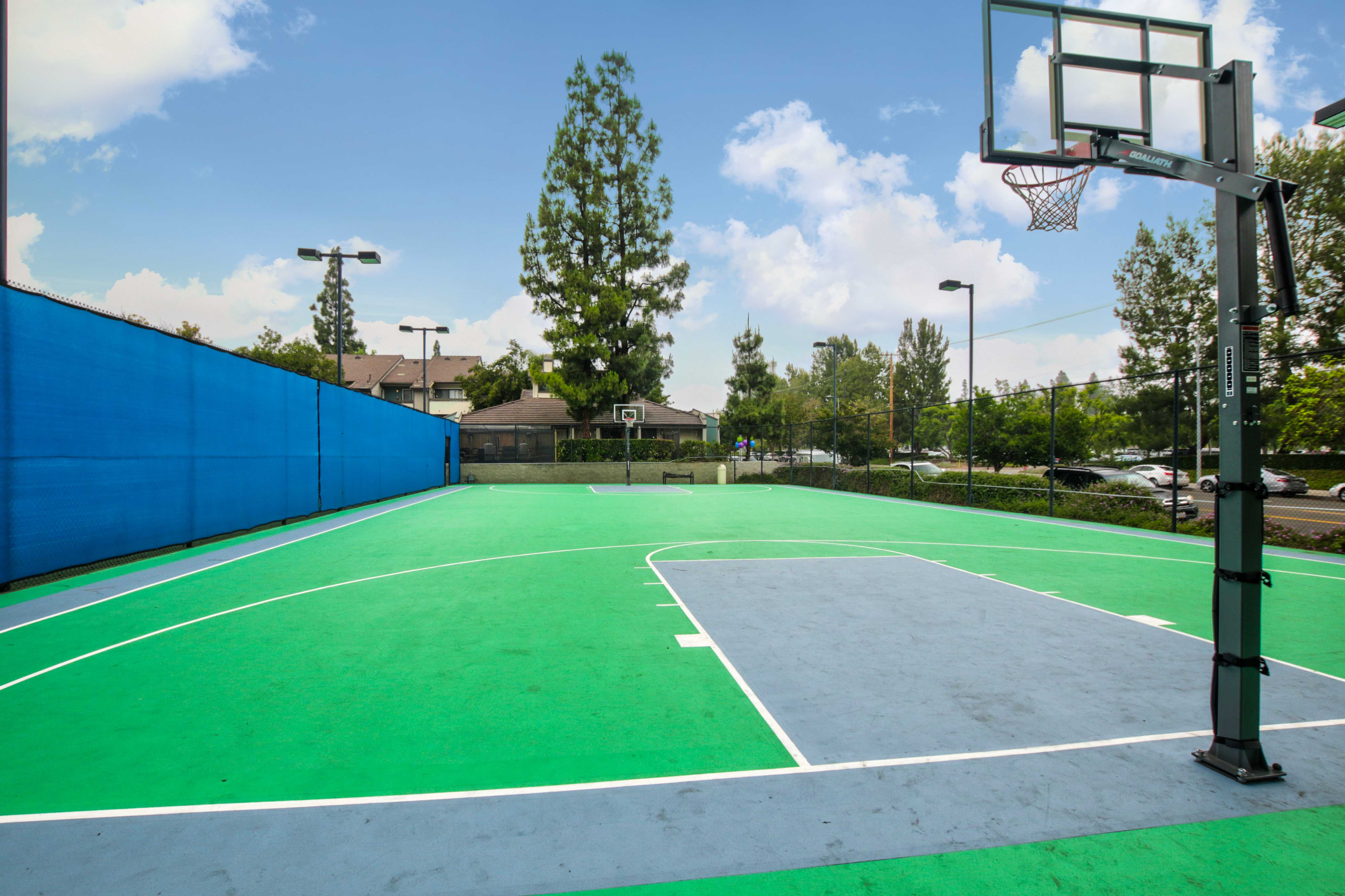 view of property full basketball court which is fenced off and located next to street