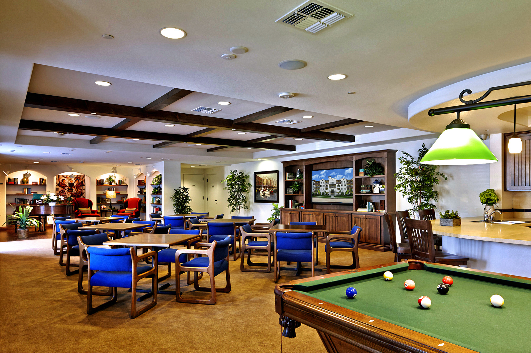 Image of community floor equipped with pool table, furniture, bar and piano
