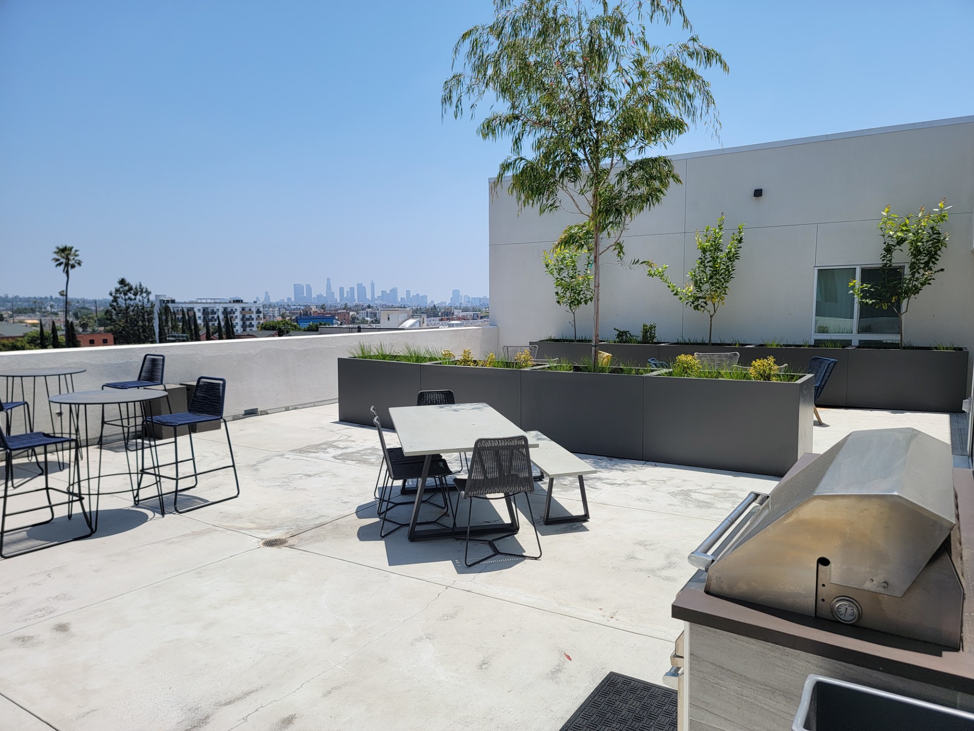 Rooftop Terrace with tables, view of DTLA,