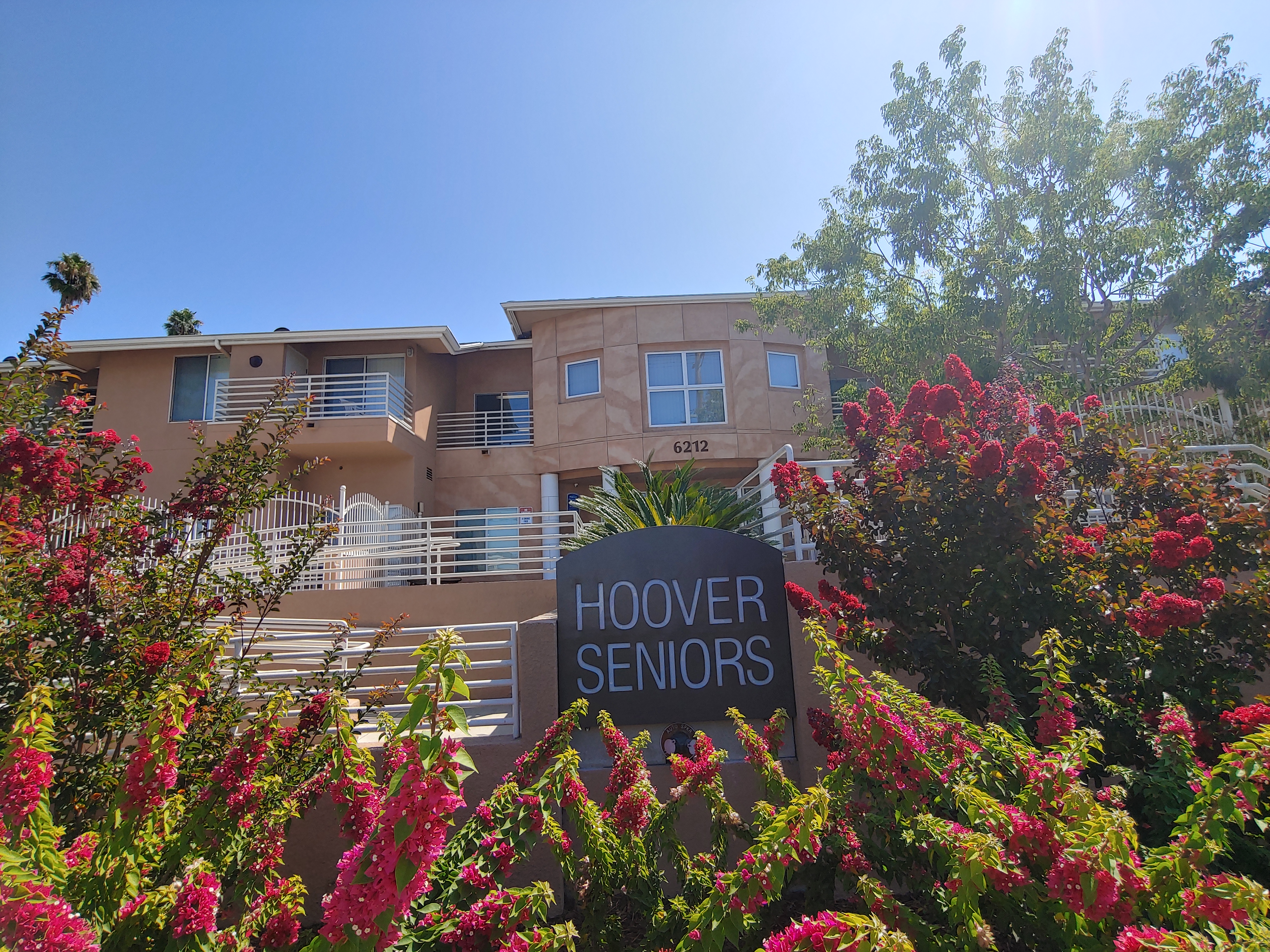View of front side of building. Large sign of building name Hoover Seniors. Accessibility ramp leading up to front of two story building. Large flower bed decorating front of building.