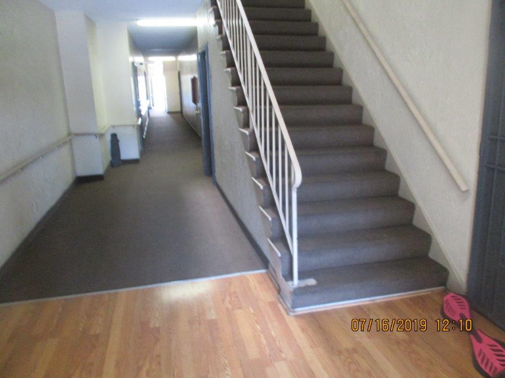 Interior view of stairs leading to the upper level and hallway on the ground floor of the property