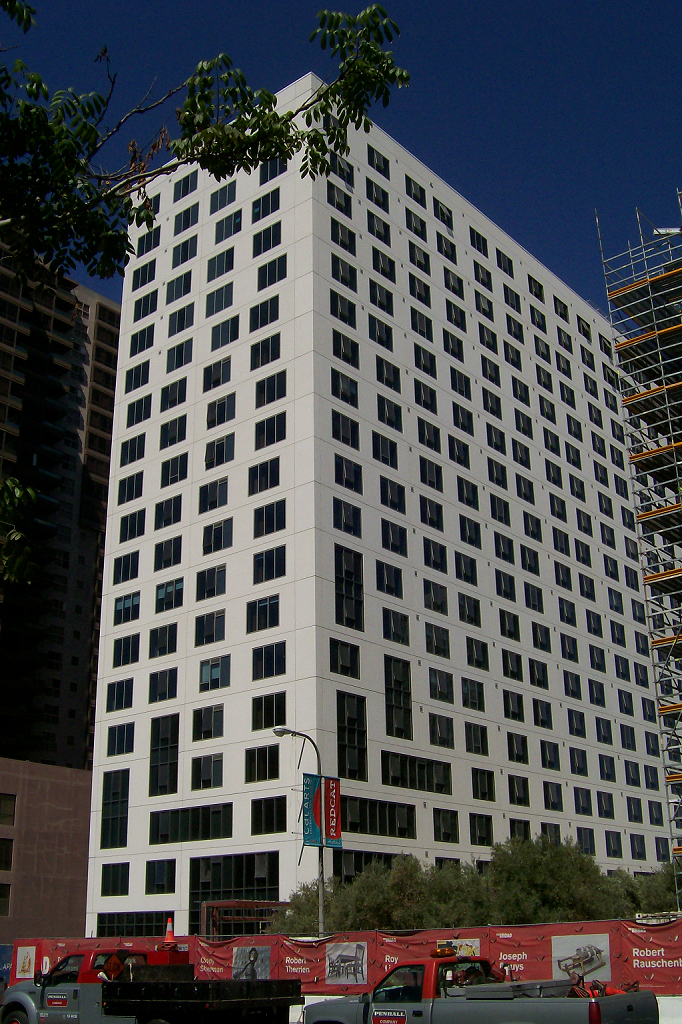 Street view of a seventeen story building in white color with black windows