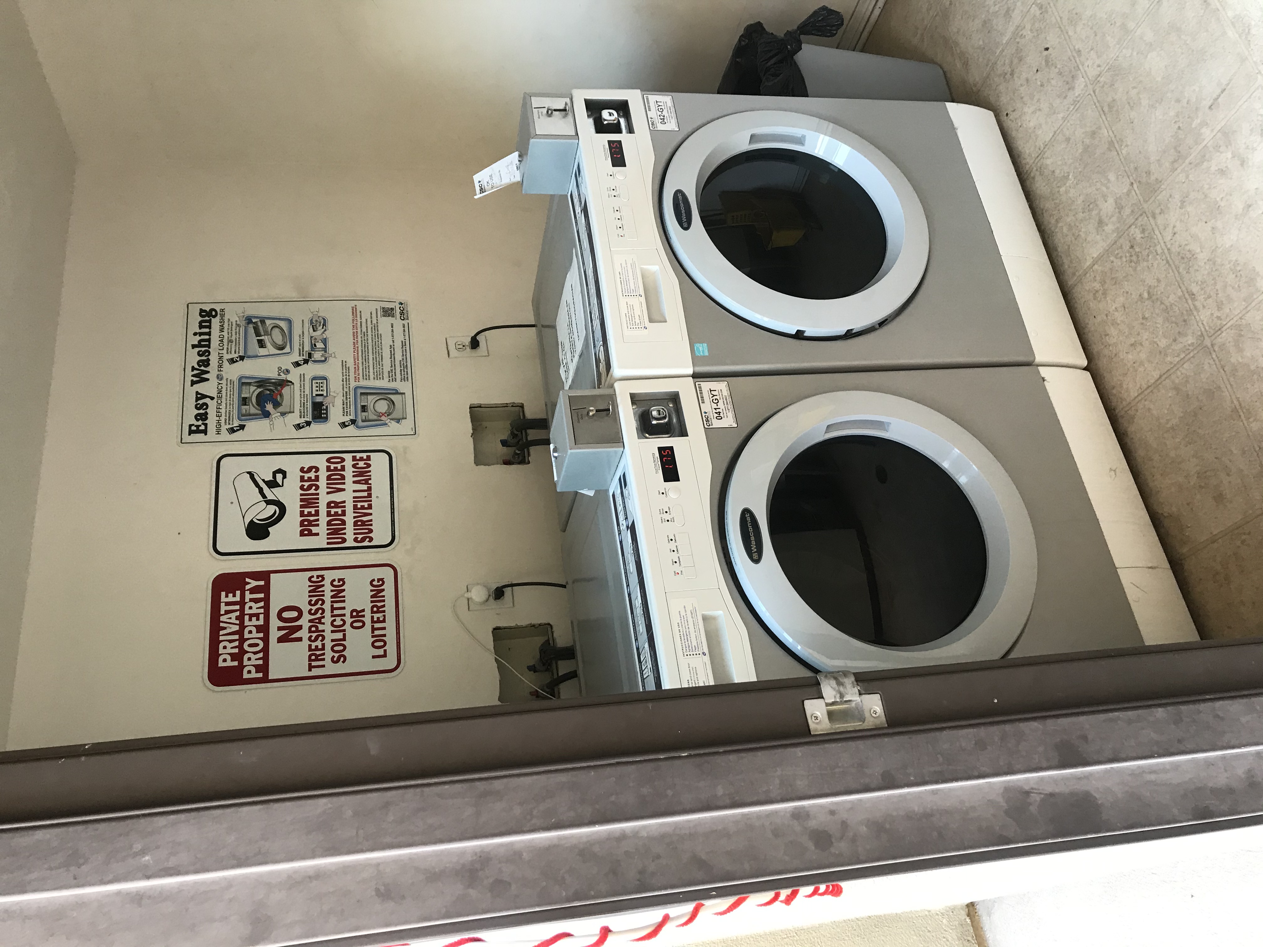 Side by side coin operated washer and dryer