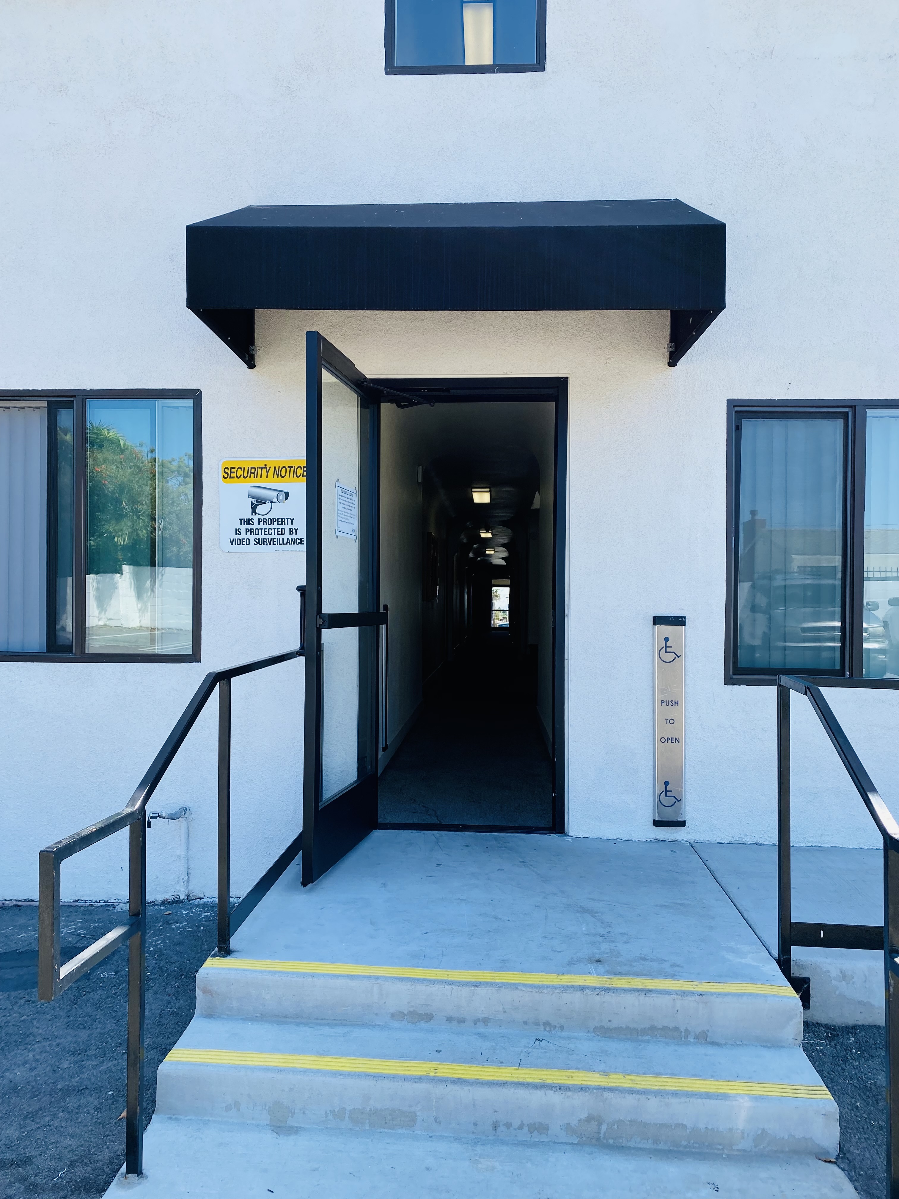 View of the back entrance door through the parking lot