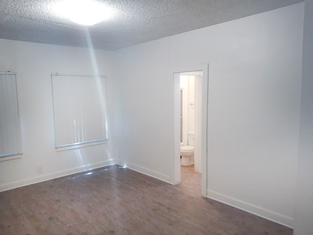 Interior view of an empty room in a unit with a restroom on the property.
