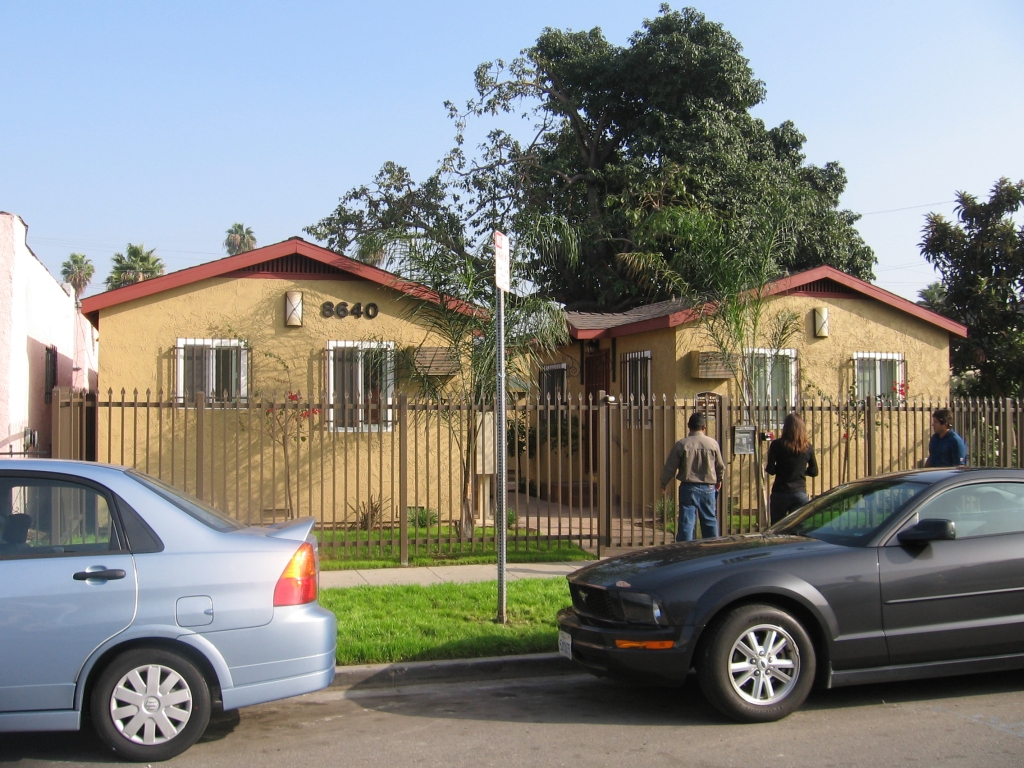 View of a yellow courtyard style gated building