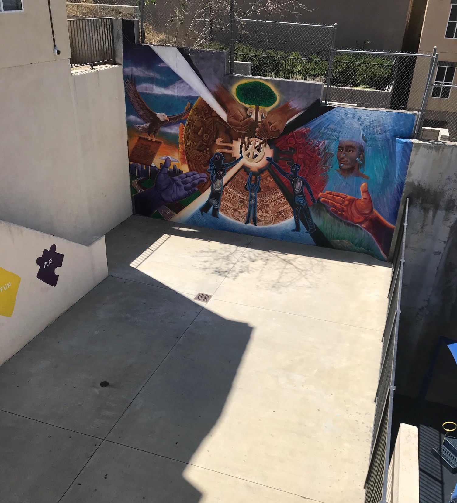 Exterior view of Lorena Terrace showing a colorful mural on a wall of the basketball court