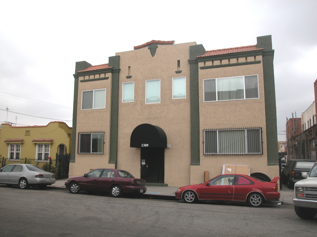 Front view of a single story building in brown and green color